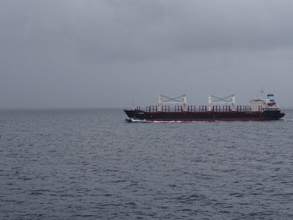 Passing another ship in the channel - very cloudy and rainy.